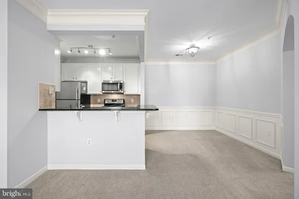 a view of kitchen with refrigerator and window