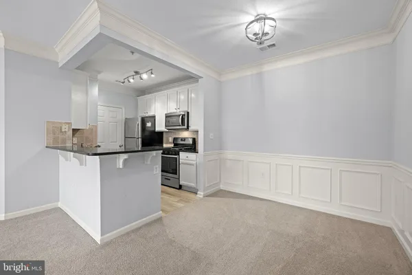 a kitchen with stainless steel appliances granite countertop a stove microwave refrigerator and sink