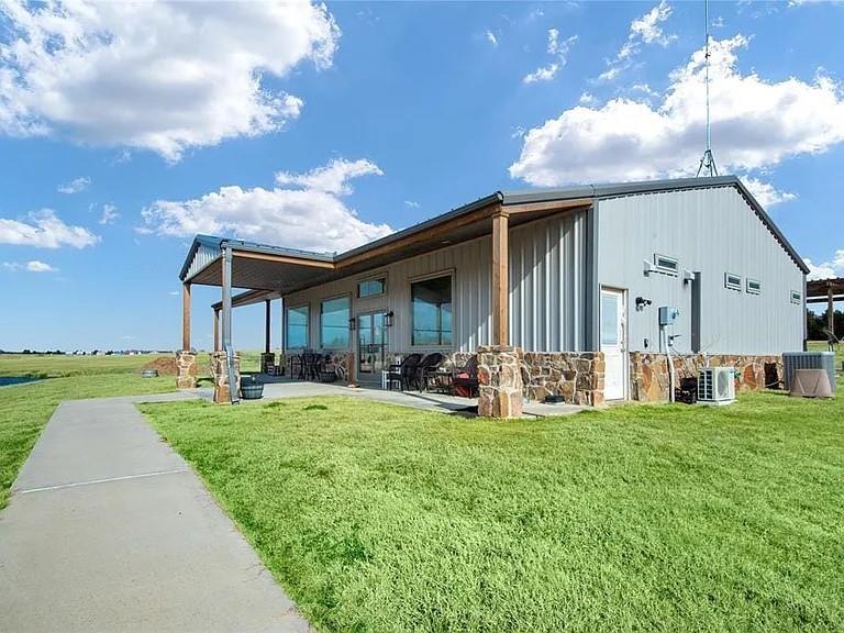 a view of a house with backyard porch and sitting area