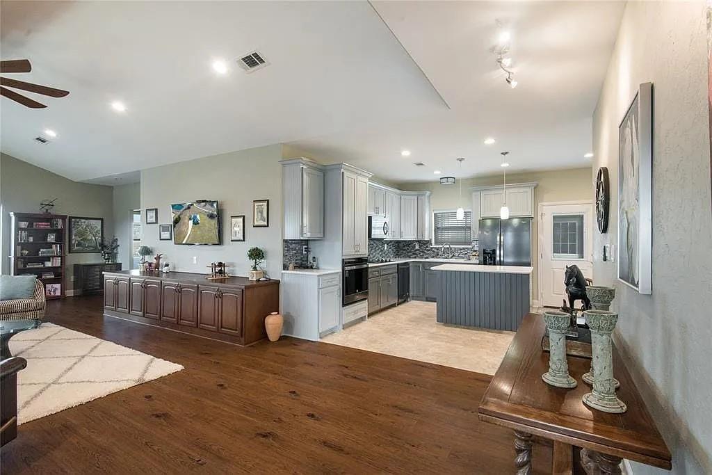 125 Heritage Road Gordonville, TX 76245 - Photo 26 of 40 a living room with furniture wooden floor and kitchen view