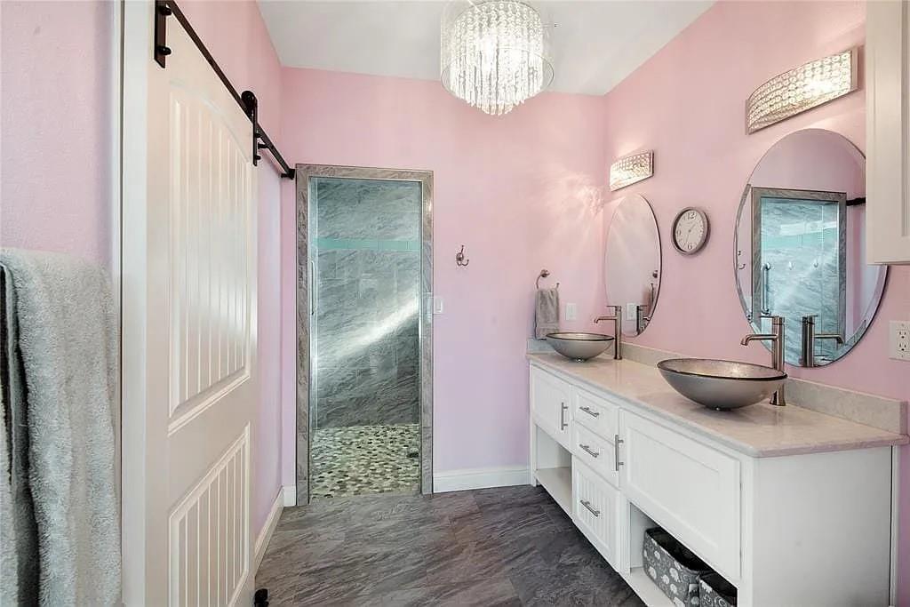 125 Heritage Road Gordonville, TX 76245 - Photo 29 of 40 a spacious bathroom with a double vanity sink and a mirror