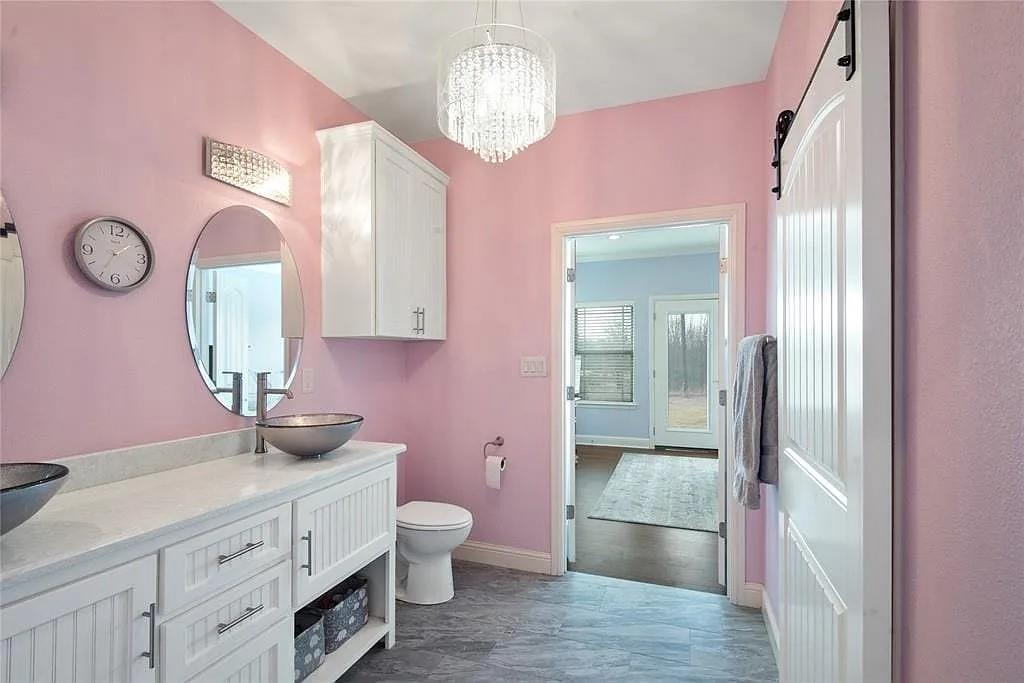 125 Heritage Road Gordonville, TX 76245 - Photo 30 of 40 a bathroom with a granite countertop sink a toilet and a mirror