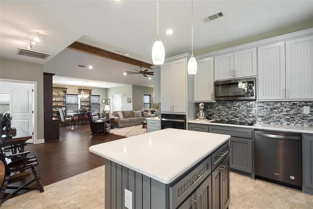 125 Heritage Road Gordonville, TX 76245 - Photo 36 of 40 a kitchen with sink refrigerator and cabinets