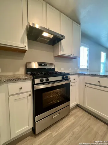 a stove top oven sitting inside of a kitchen