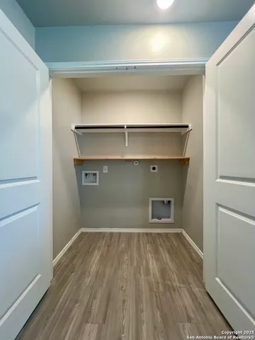 a room with a wooden floor and a window