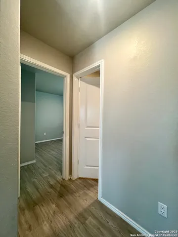 a view of a room with wooden floor