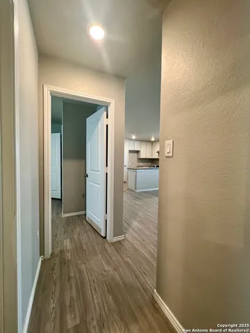 a view of hallway with wooden floor
