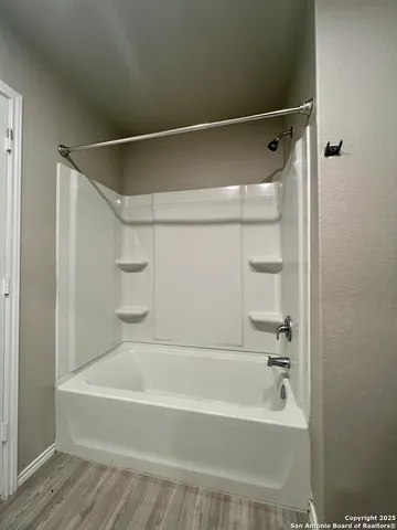 a bathroom with a bathtub and a shower