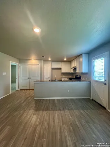 a view of kitchen and kitchen with wooden floor
