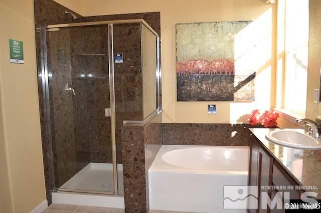 9035 Sydmesa Drive Reno, NV 89523 - Photo 5 of 8 a bathroom with a bathtub and a shower