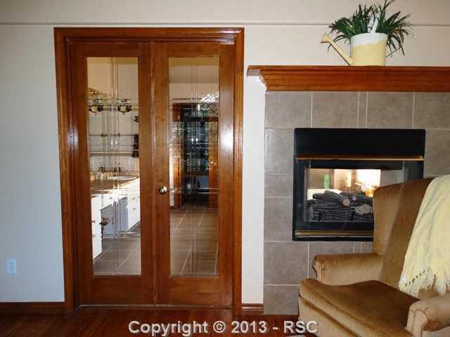 9065 Rutledge Drive Colorado Springs, CO 80920 - Photo 11 of 25 Double-sided gas fireplace between the master bedroom and master bathroom for that extra touch of luxury.