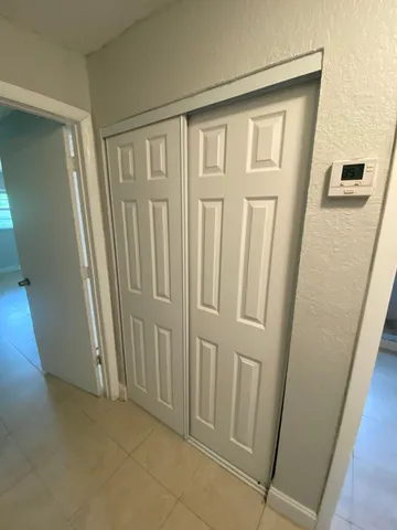 a white toilet sitting next to a bathroom sink and a mirror