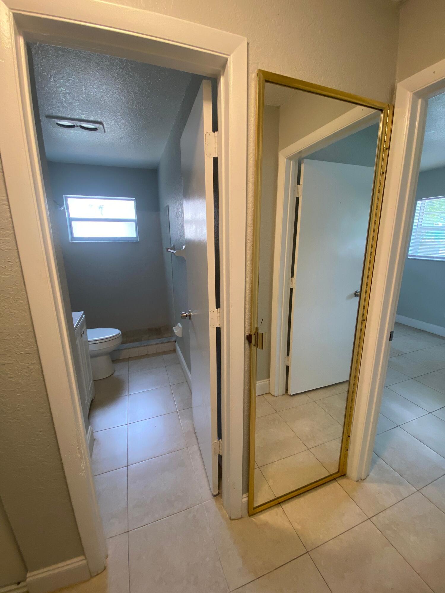 4327 Cocoanut Road West Palm Beach, FL 33406 - Photo 12 of 24 a view of a hallway view with wooden floor and a bathroom