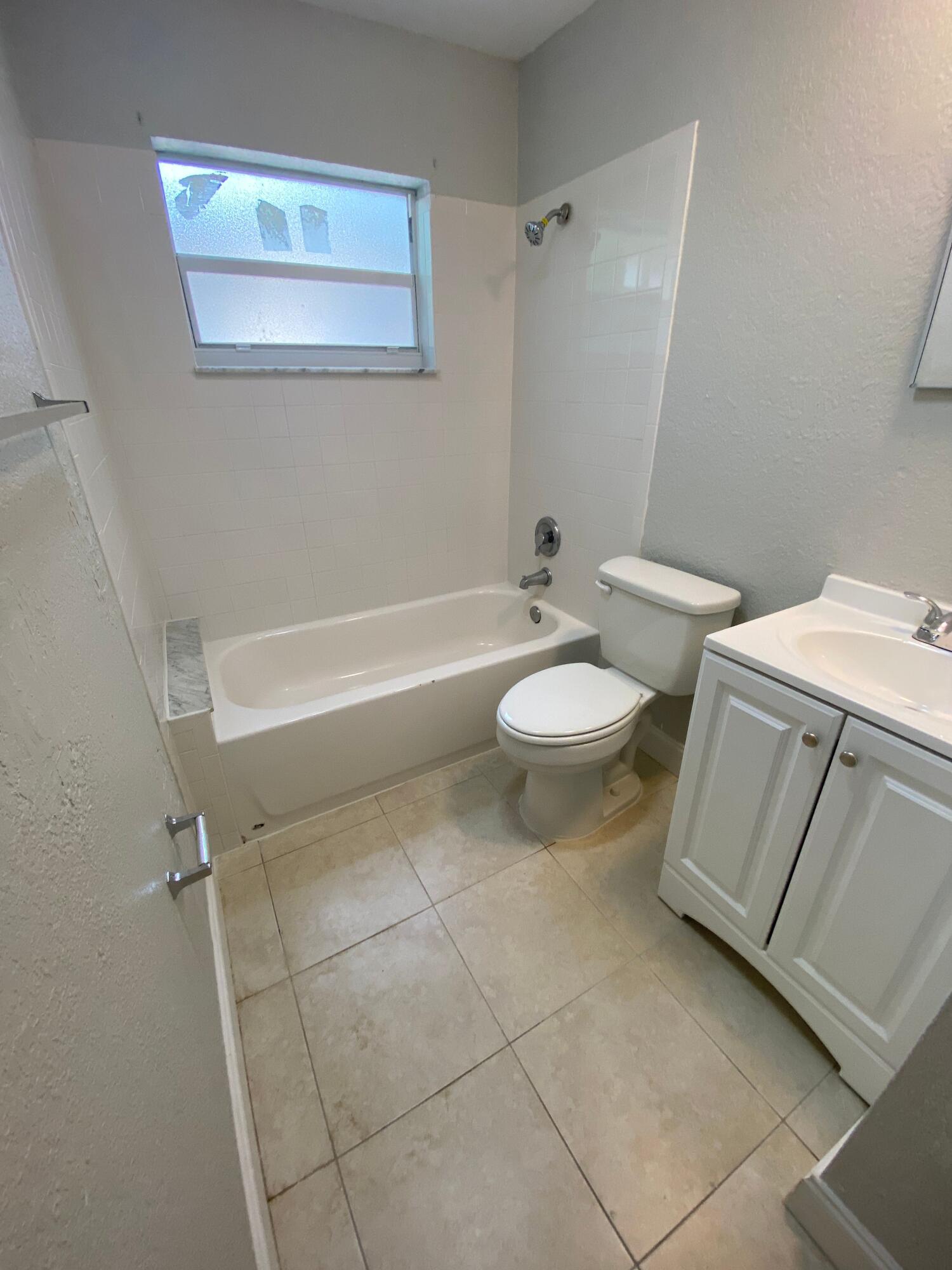 4327 Cocoanut Road West Palm Beach, FL 33406 - Photo 22 of 24 a bathroom with a sink a toilet and bathtub
