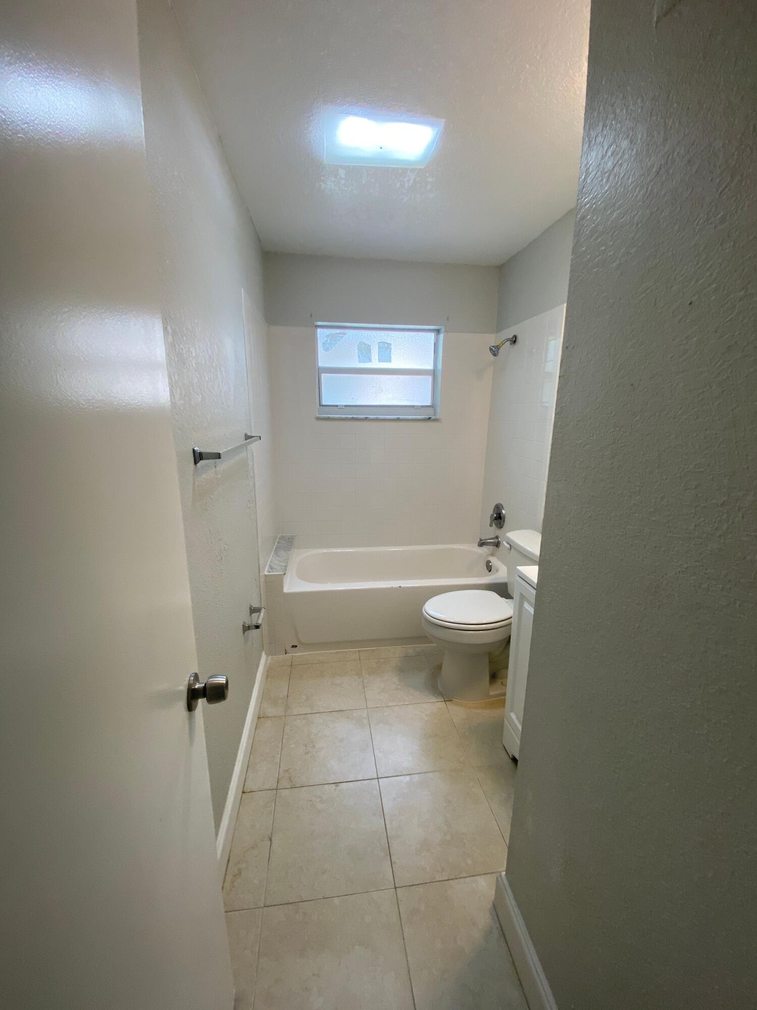 4327 Cocoanut Road West Palm Beach, FL 33406 - Photo 23 of 24 a bathroom with a toilet and a shower