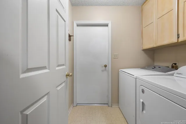 a view of a storage & utility room with dryer and washer