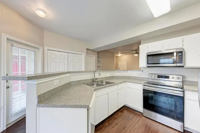 a kitchen with a stove microwave and sink