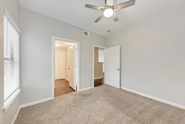 a view of a big room with closet and chandelier fan