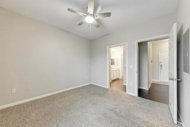 an empty room with fan and entrance