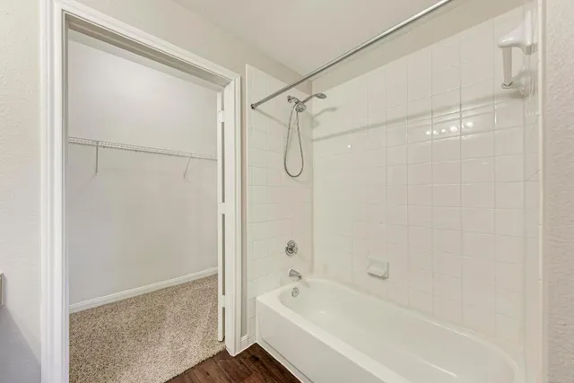 a bathroom with a bathtub and a shower