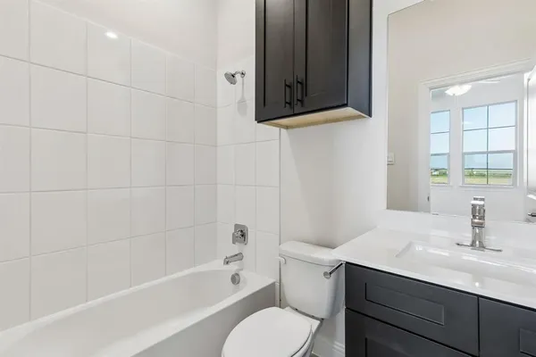 a bathroom with a sink toilet a mirror and shower