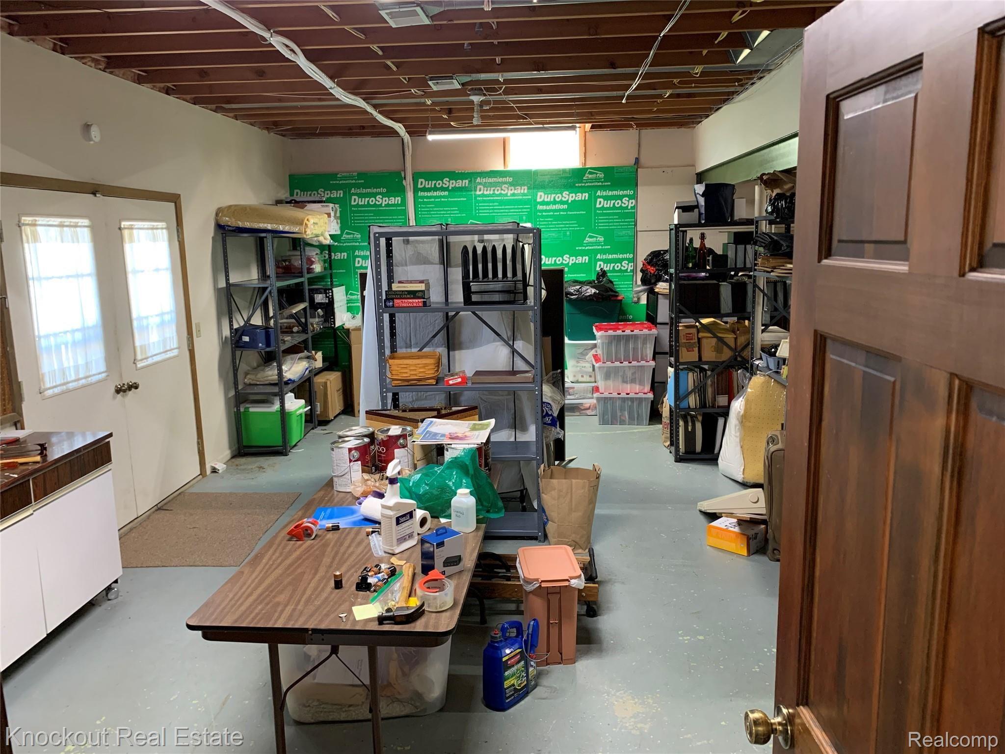9252 Ormes Road Vassar, MI 48768 - Photo 50 of 64 Storage/woodshop/workroom in basement with walkout access to river