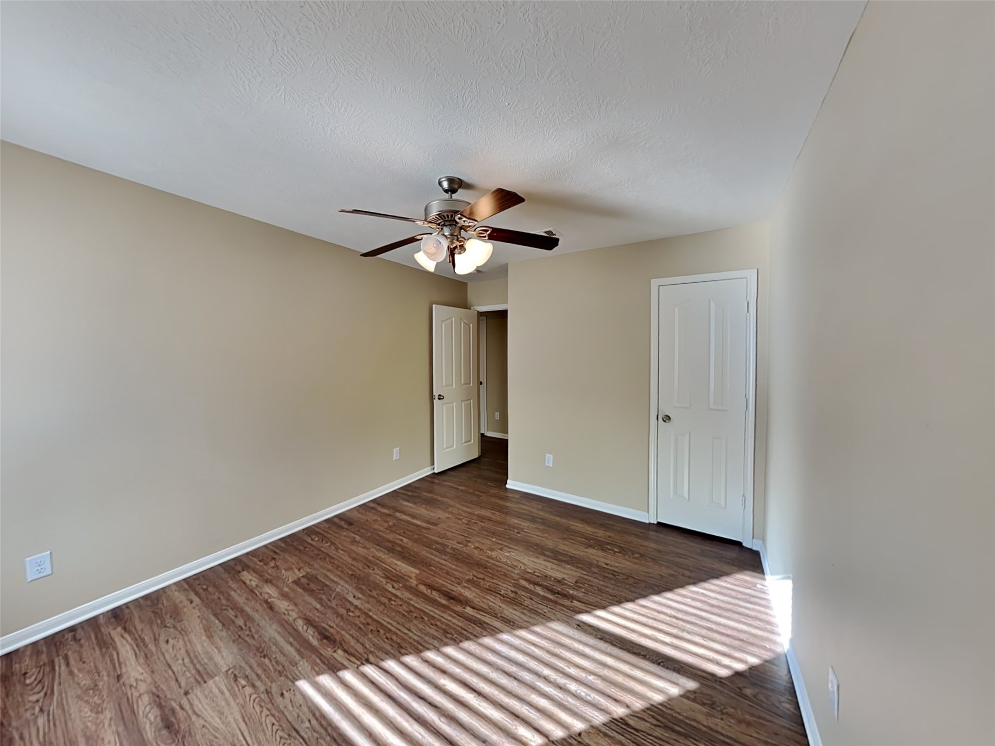 8119 Silent Deep Drive Rosenberg, TX 77469 - Photo 13 of 20 a view of a room with wooden floor and chandelier fan