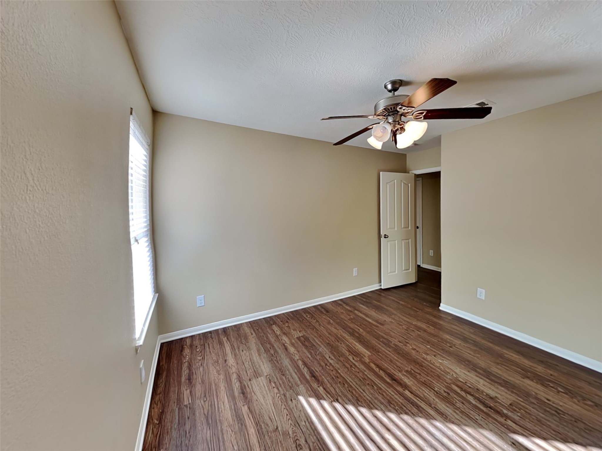 8119 Silent Deep Drive Rosenberg, TX 77469 - Photo 14 of 20 wooden floor in an empty room with a window
