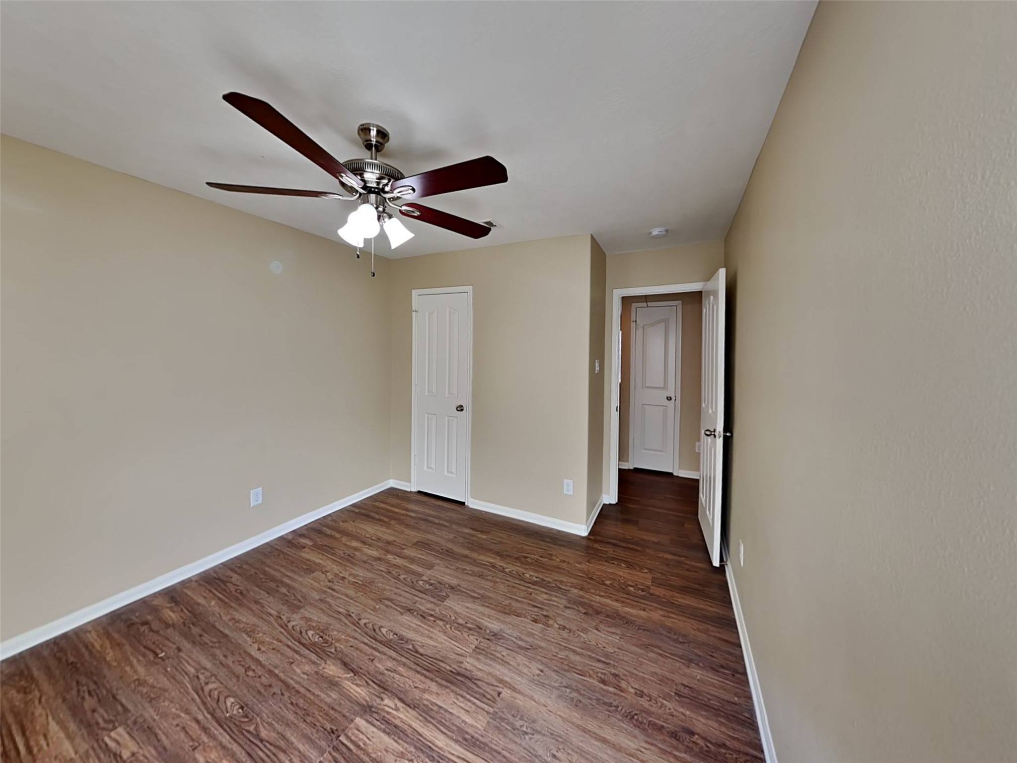 8119 Silent Deep Drive Rosenberg, TX 77469 - Photo 18 of 20 a view of an empty room with window a ceiling fan and wooden floor