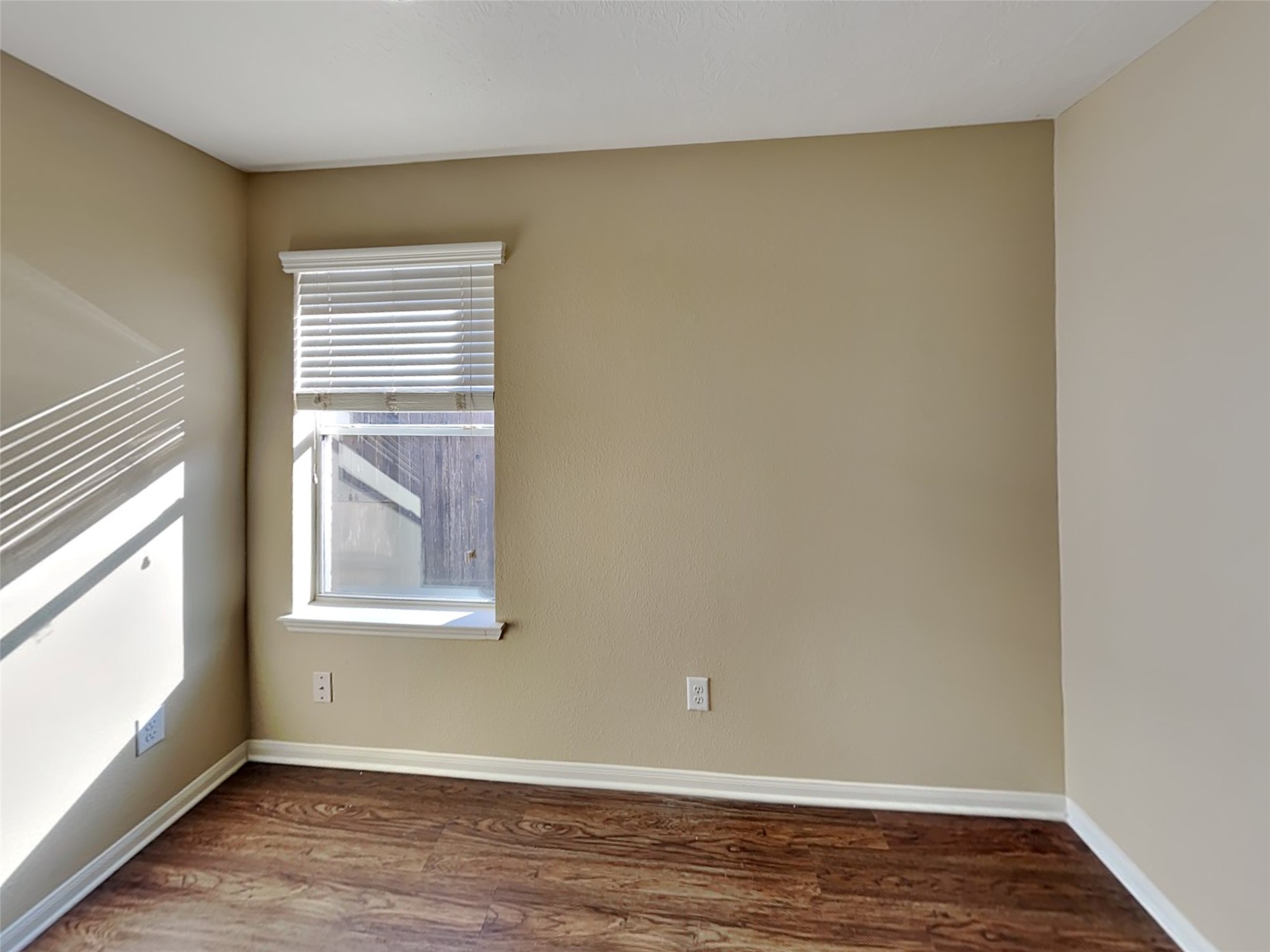 8119 Silent Deep Drive Rosenberg, TX 77469 - Photo 19 of 20 a view of an empty room with wooden floor and a window