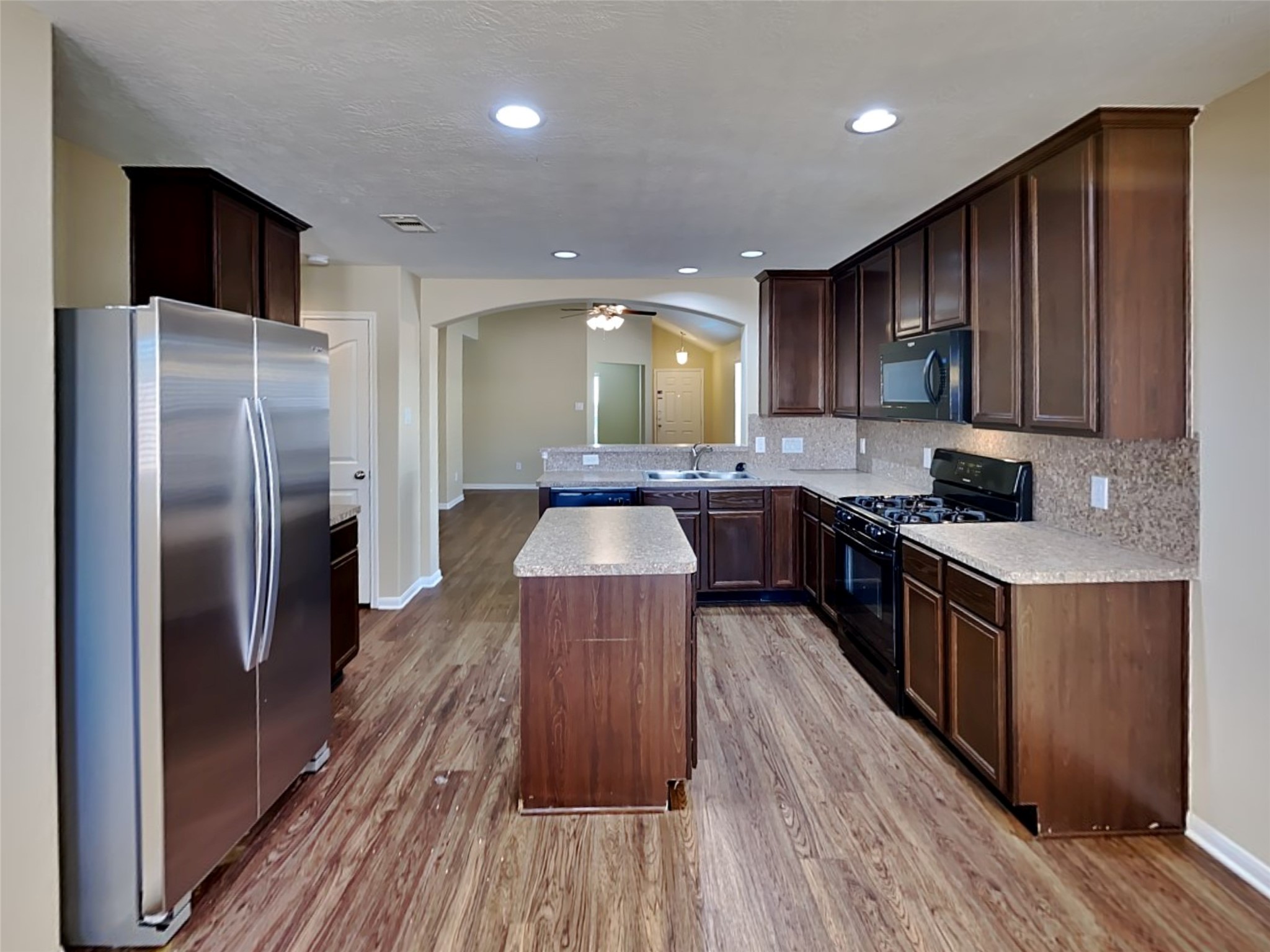 8119 Silent Deep Drive Rosenberg, TX 77469 - Photo 2 of 20 a kitchen with stainless steel appliances granite countertop a refrigerator a sink dishwasher a stove and a microwave oven on granite countertops