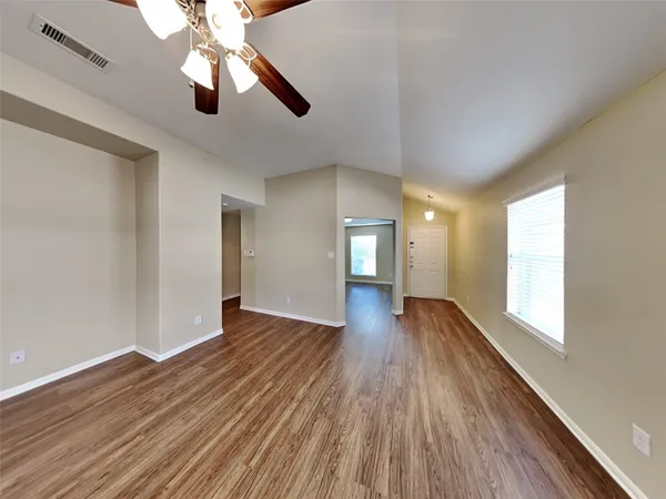 wooden floor in an empty room with a window