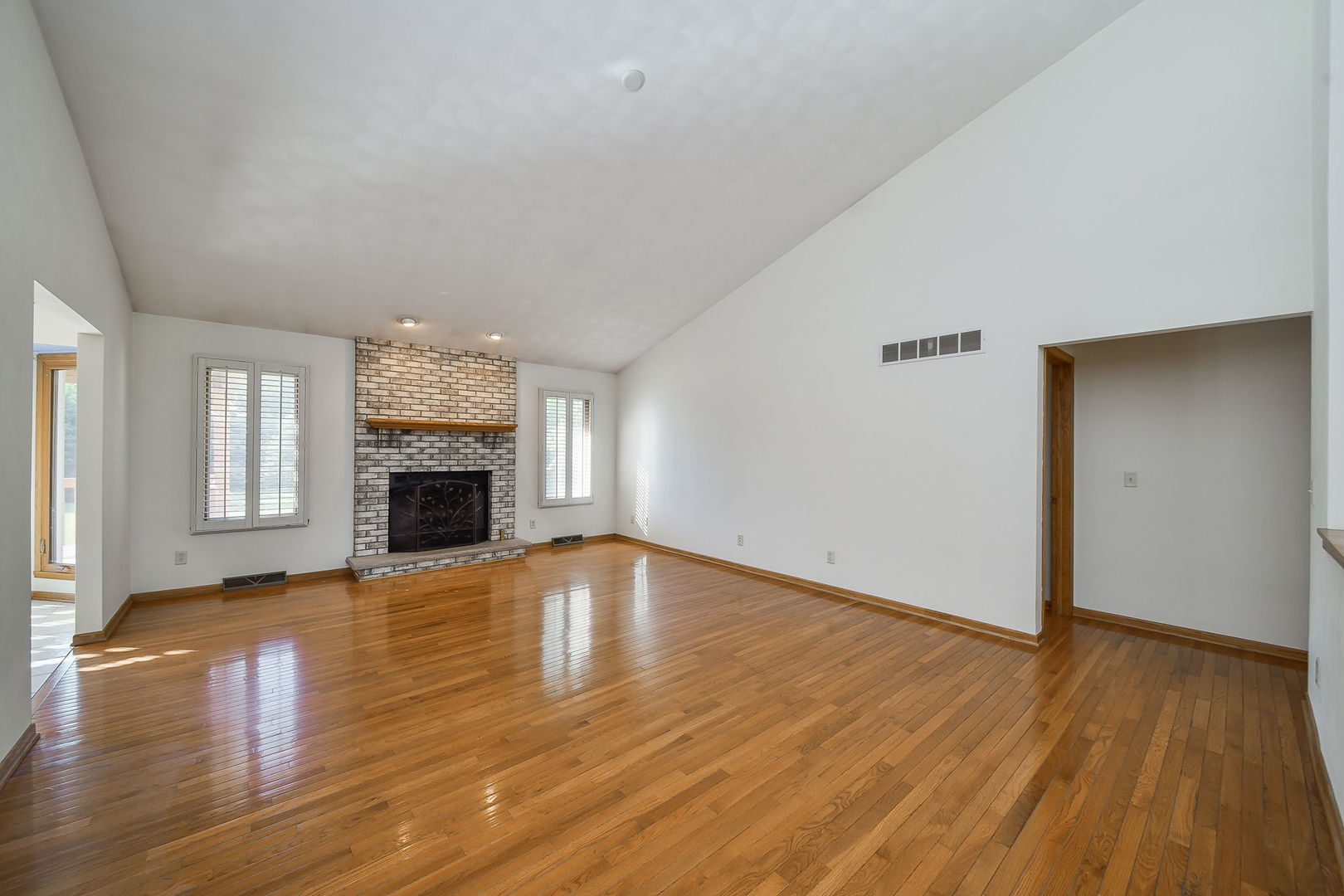 2917 Prairie Road Belvidere, IL 61008 - Photo 4 of 23 a view of empty room with wooden floor and fireplace
