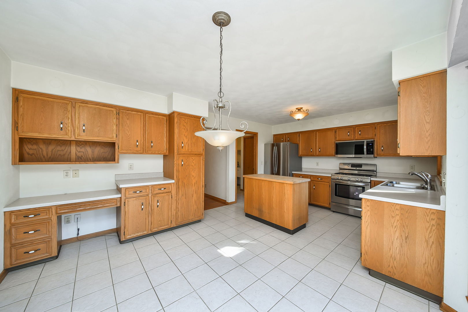 2917 Prairie Road Belvidere, IL 61008 - Photo 8 of 23 a kitchen with stainless steel appliances kitchen island granite countertop a stove a sink and a refrigerator