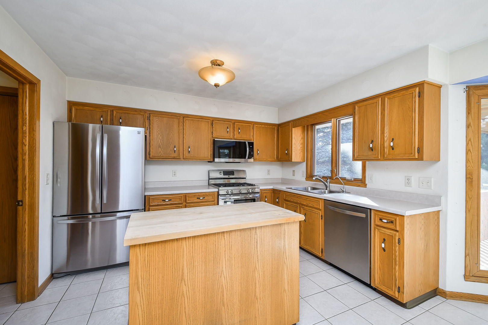 2917 Prairie Road Belvidere, IL 61008 - Photo 9 of 23 a kitchen with stainless steel appliances granite countertop a refrigerator a stove top oven a sink dishwasher and wooden cabinets