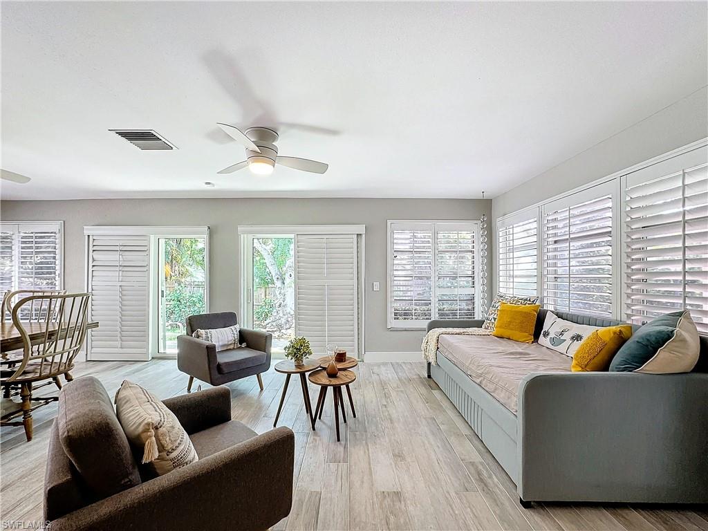 9 Knights Bridge Road, Unit 30 Naples, FL 34112 - Photo 12 of 47 a living room with furniture and a large window