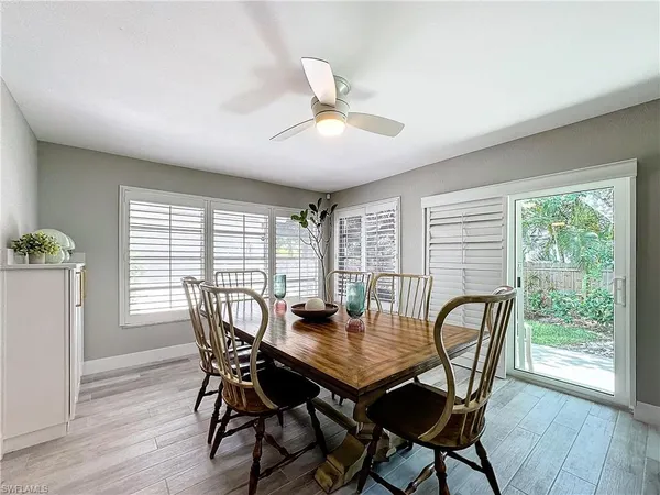 a view of a dining room with furniture window and wooden floor