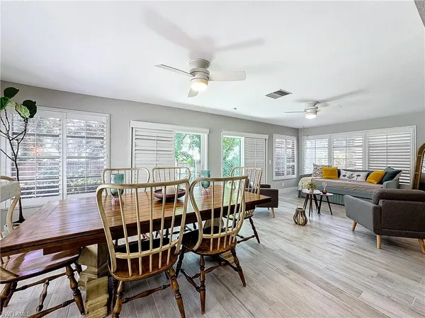 a view of a dining room with furniture window and wooden floor