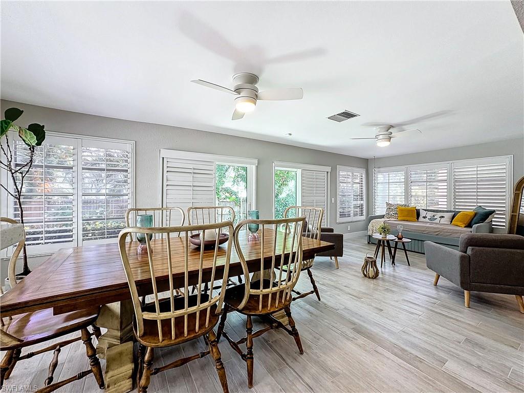 9 Knights Bridge Road, Unit 30 Naples, FL 34112 - Photo 19 of 47 a view of a dining room with furniture window and wooden floor