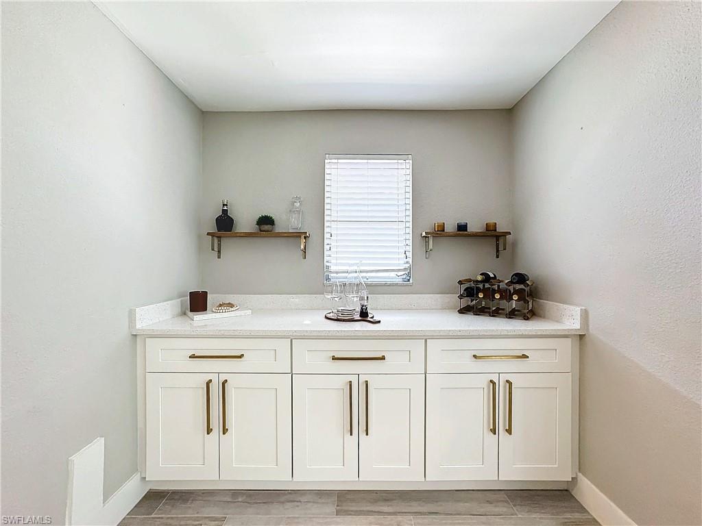 9 Knights Bridge Road, Unit 30 Naples, FL 34112 - Photo 22 of 47 a kitchen with white cabinets and sink