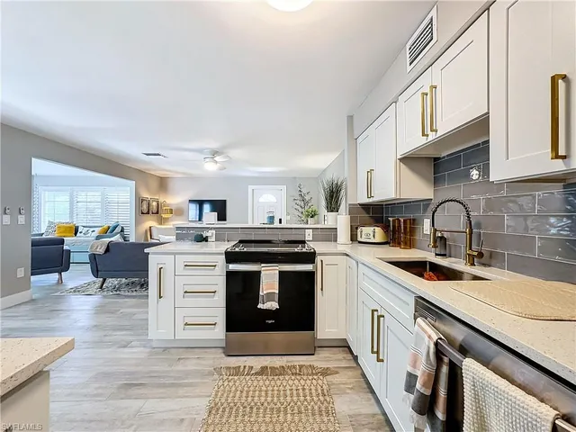 a kitchen with stainless steel appliances granite countertop a stove and a sink