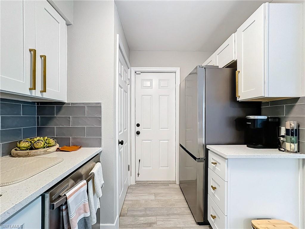 9 Knights Bridge Road, Unit 30 Naples, FL 34112 - Photo 27 of 47 a kitchen with stainless steel appliances a refrigerator sink and cabinets