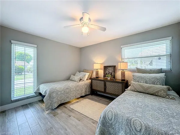 a bed room with two beds and a window