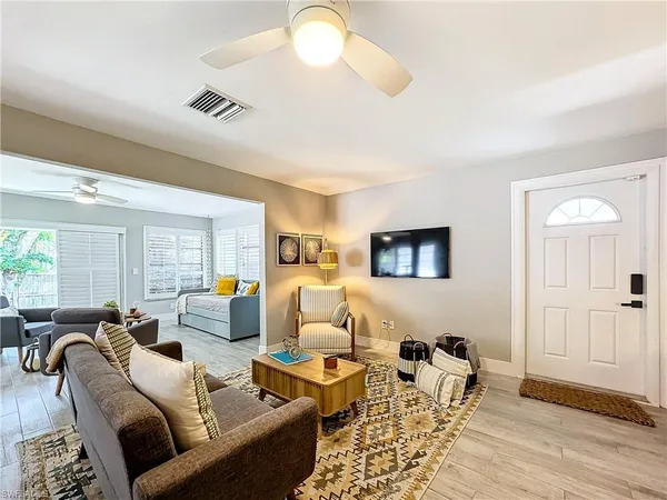a living room with furniture and a wooden floor