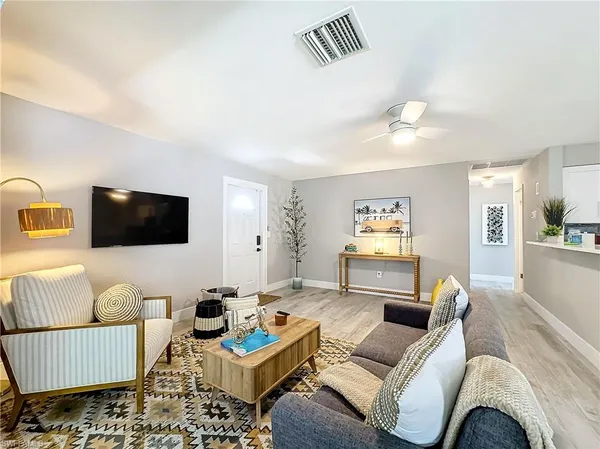 a living room with furniture and a flat screen tv