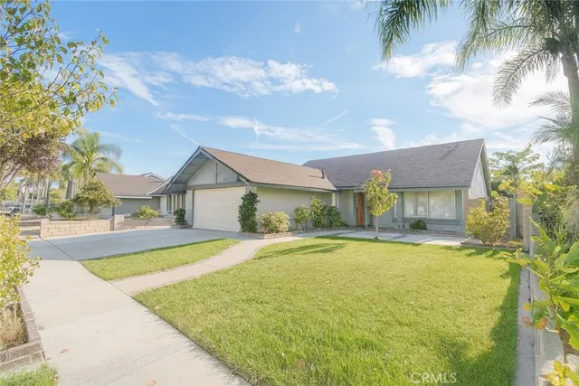 a view of a house with swimming pool and a yard
