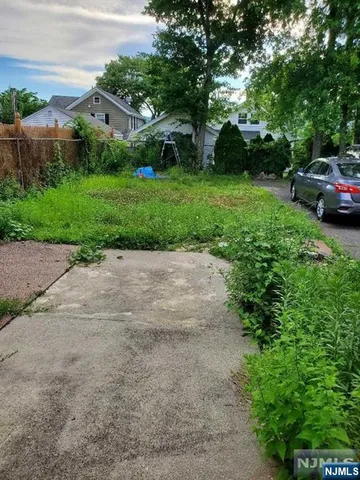 a view of a street with a car parked in the background
