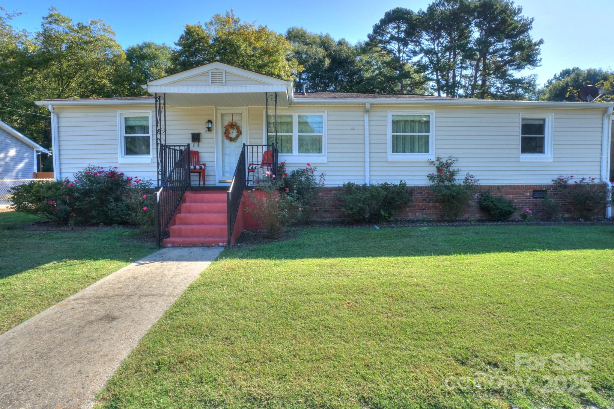 a front view of house with yard and green space