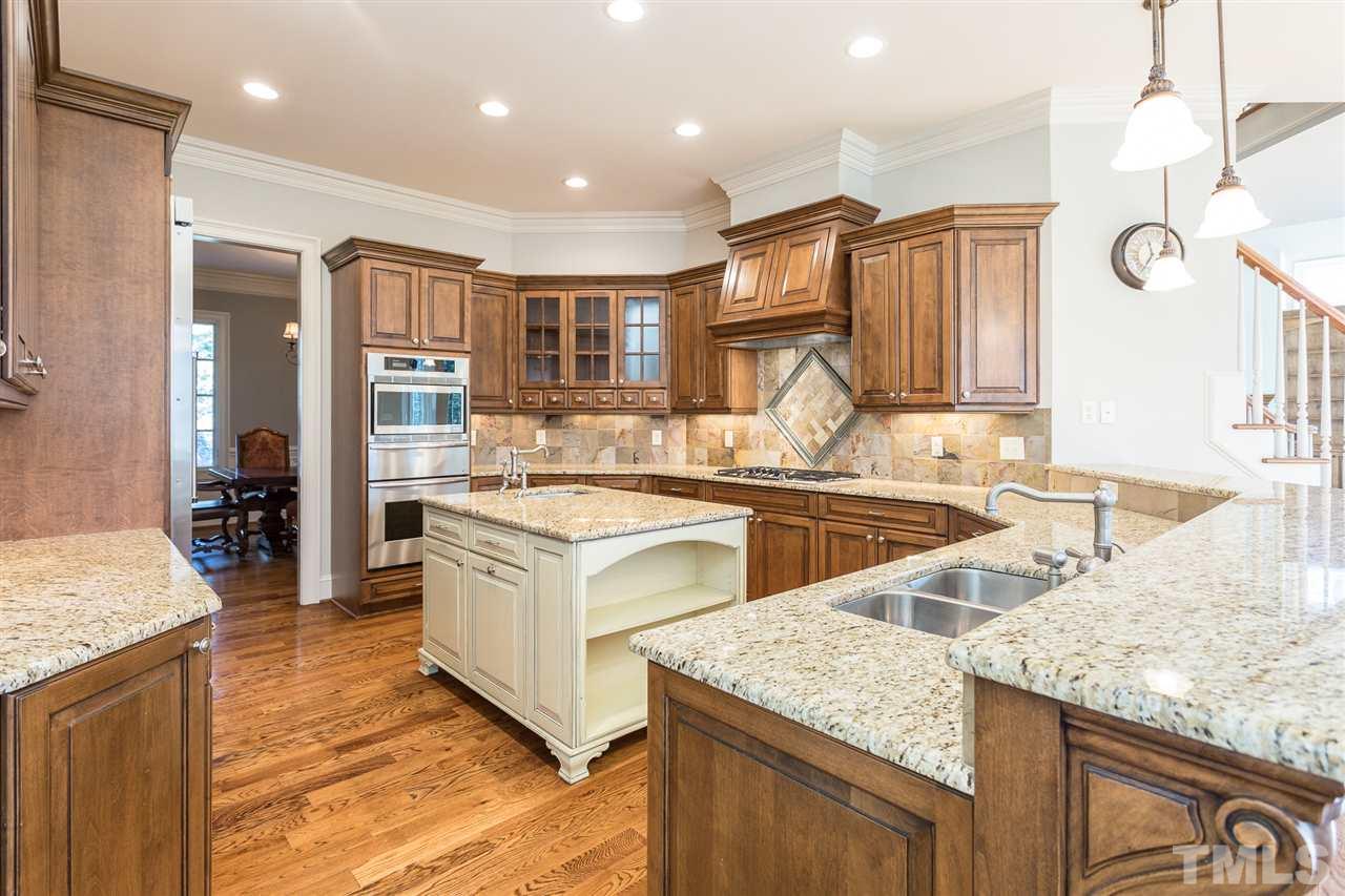 7005 Potomac Court Raleigh, NC 27613 - Photo 8 of 30 a kitchen with stainless steel appliances granite countertop a sink a stove and a wooden floors