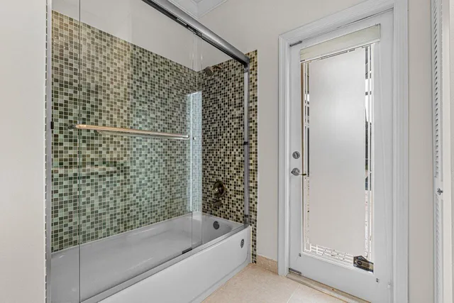 a bathroom with a bathtub and shower
